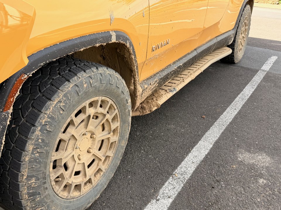 Rivian wheel and rock slider after trail use