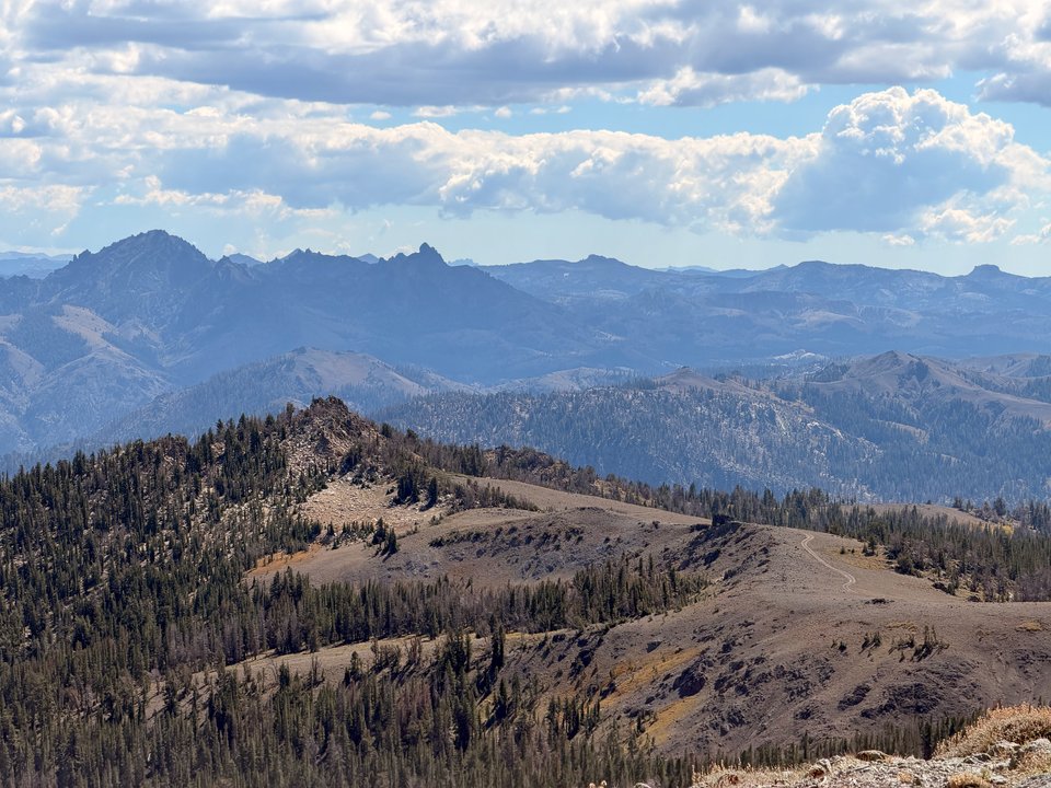 Rivian R1T parked on an open mountain trail