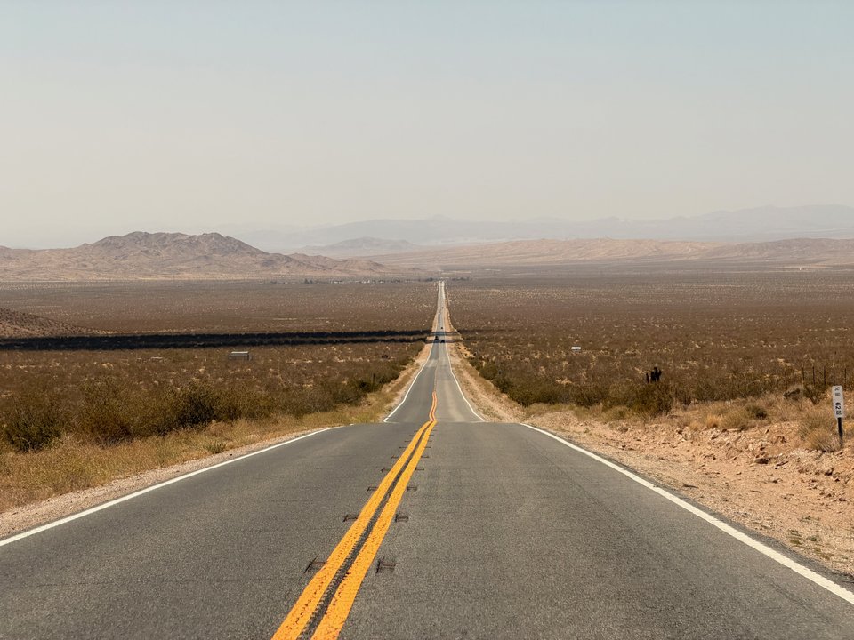 A long desert road leading into remote country